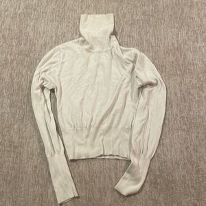 Large turtle neck sweater.